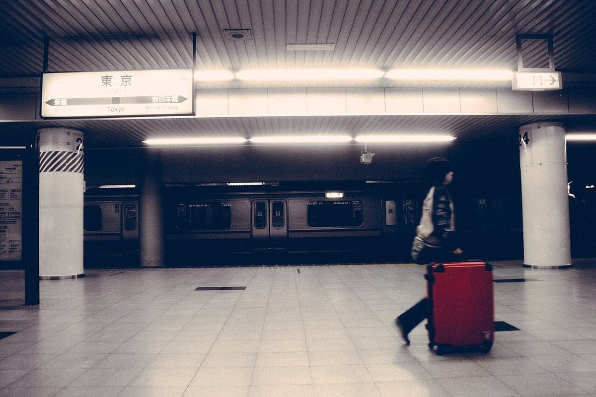 A wheeled suitcase standing on a station platform