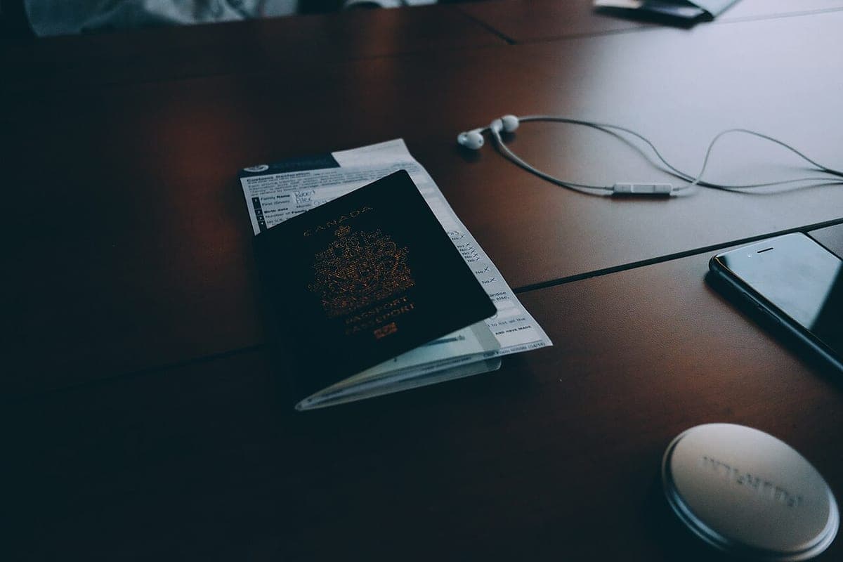 A passport and travel documents laid out on a desk